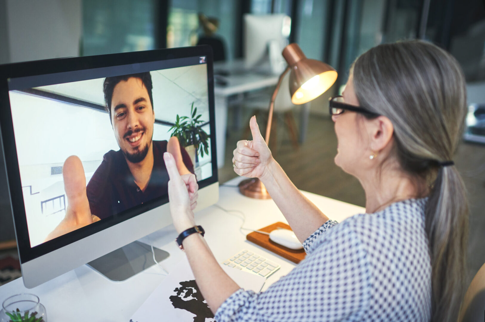 Shot of a young man showing thumbs up during an online counselling session with a psychologist